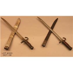 Lot of 2 late war Japanese arisaka bayonets.  1  metal, 1 wood.  Est. $150 - $300