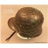 Image 2 : German WW II helmet with green cord netting intact  and a German 10 Mark paper currency held under  