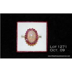 Ladies 14kt yellow gold opal/ruby ring, 10 grams,  set with one oval opal with red fire weighing  ap