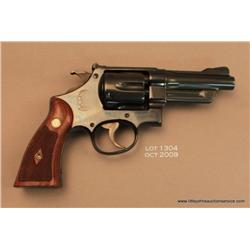 Smith & Wesson Registered Model DA revolver, .357  Magnum cal., 4” barrel, blue finish, checkered  m
