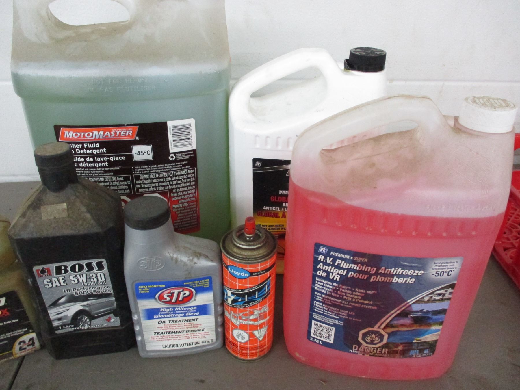 Partial containers with oil, antifreeze, washer fluid