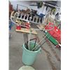 Image 2 : Garbage can with 2 rakes, bucksaw, shovels