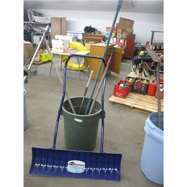 Garbage can with rake, hoe, snow pusher, plant stand