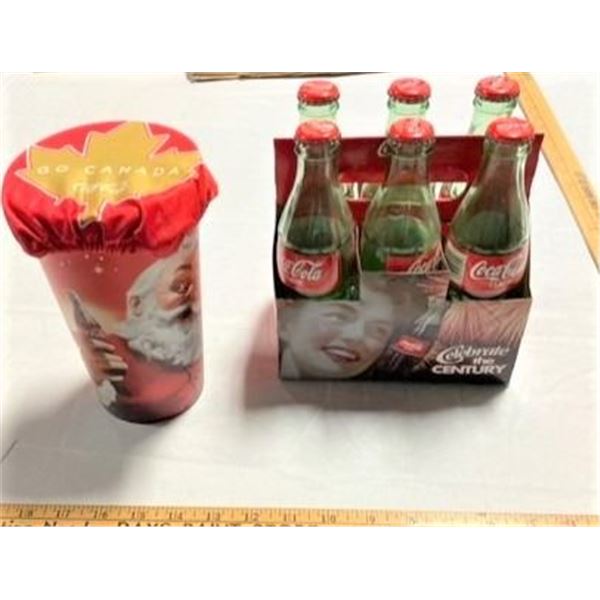 Six Classic Coca Cola bottles and One cup