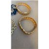 Image 2 : 4 BRACELETS - 2 VINTAGE GOLD TONE BANGLES, 2 SKULL BEAD BRACELETS, AND  GOLD TONE GRYFFINDOR BRACELE