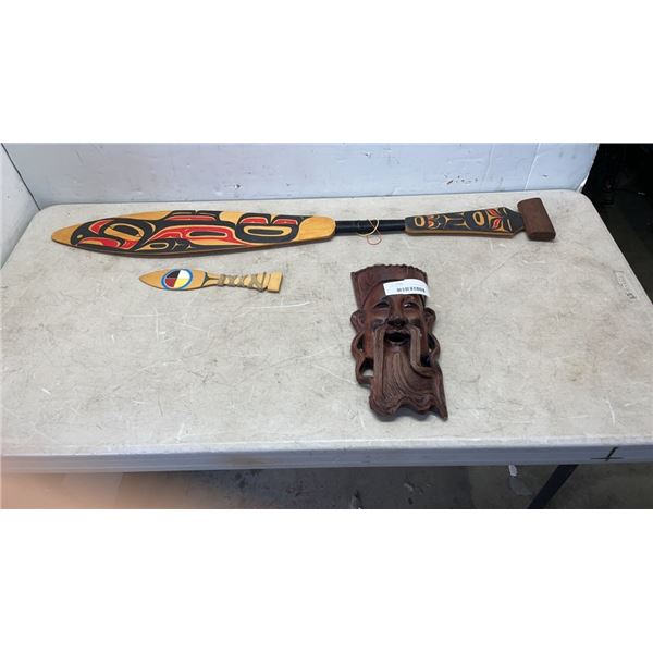 CARVED EASTERN HEAD WITH FIRST NATION PADDLE AND DAGGER