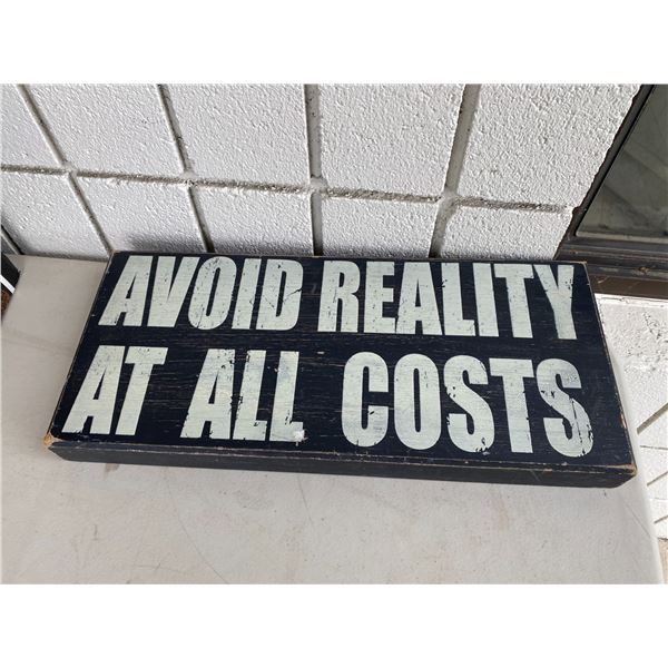 Avoid reality at all costs sign