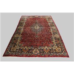 A Persian Mashad Wool Rug.