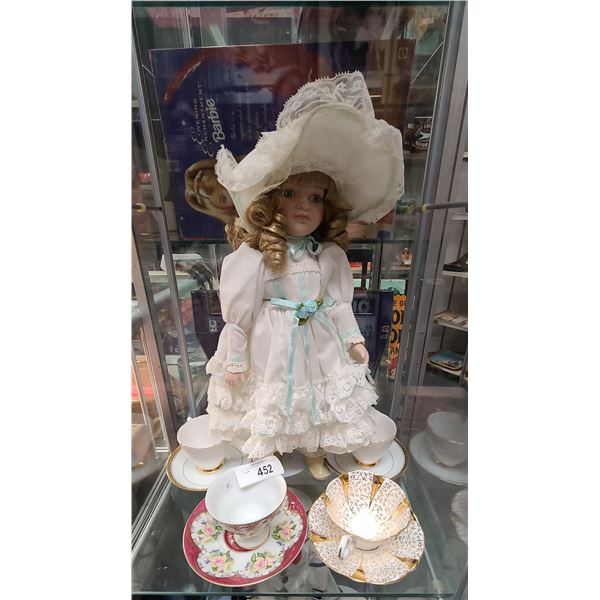 FOUR BONE CHINA TEACUPS/SAUCERS & PORCELAIN DOLL