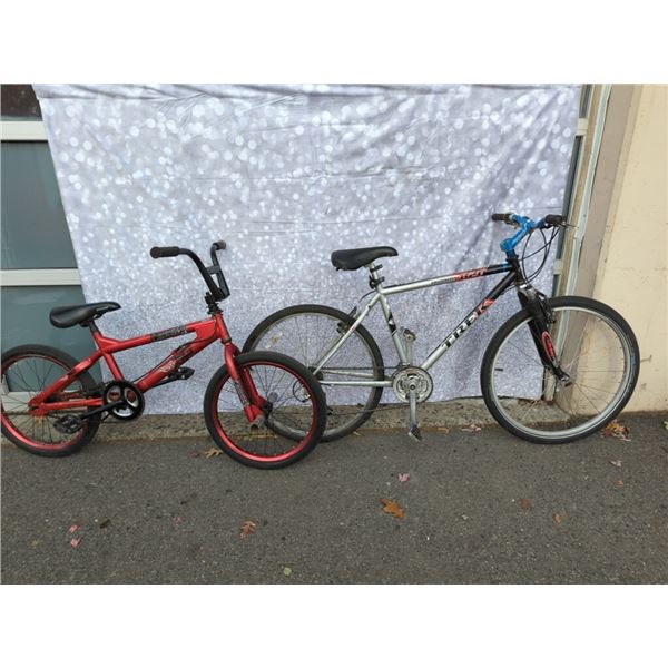 BLACK TREK BIKE. AND RED BMX BIKE