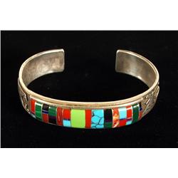 Signed Zuni story teller inlaid bracelet