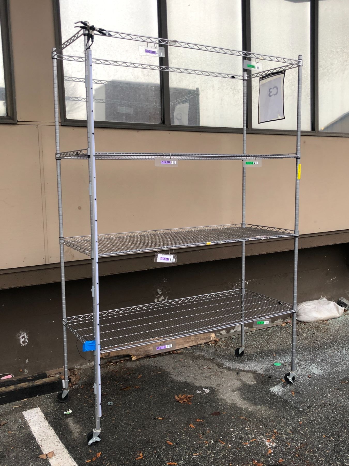 Four tier industrial rolling shelving rack (approx. 7 1/2ft tall x 59in ...