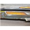 Image 3 : two Ford 100 vehicle badges with orange reflectors on rough cut metal