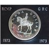 Image 1 : 1973 RCMP Centennial Specimen Silver Dollar. Lightly Toned. Housed in its original RCM black clamshe