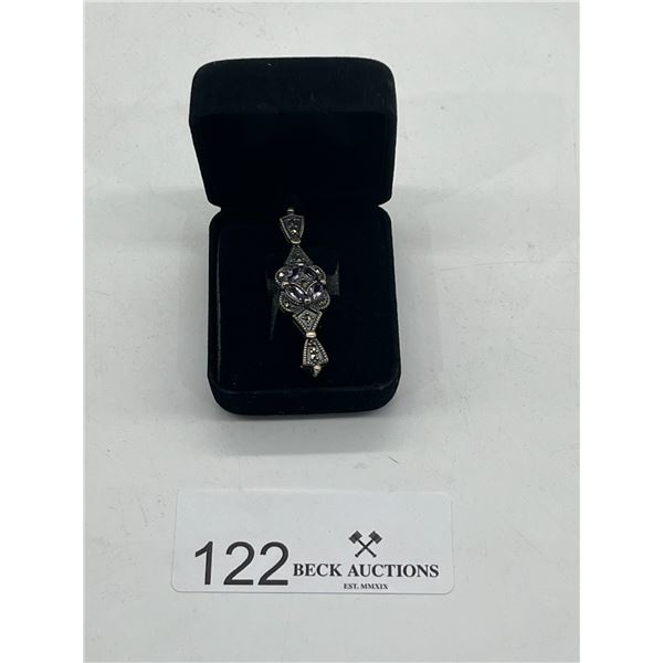 Silver pin with purple gemstones