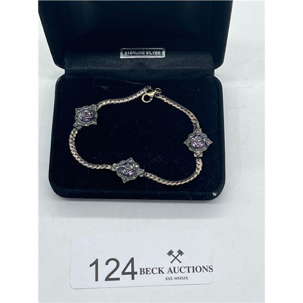 Silver bracelet with purple gemstones