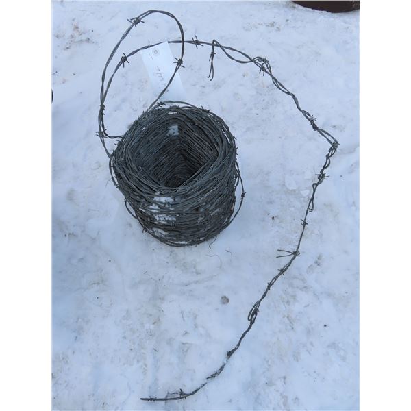 Partial roll of barbed wire