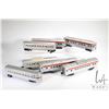 Image 1 : Seven vintage Lionel O gauge passenger cars including three tin "Santa Fe" and four plastic includin