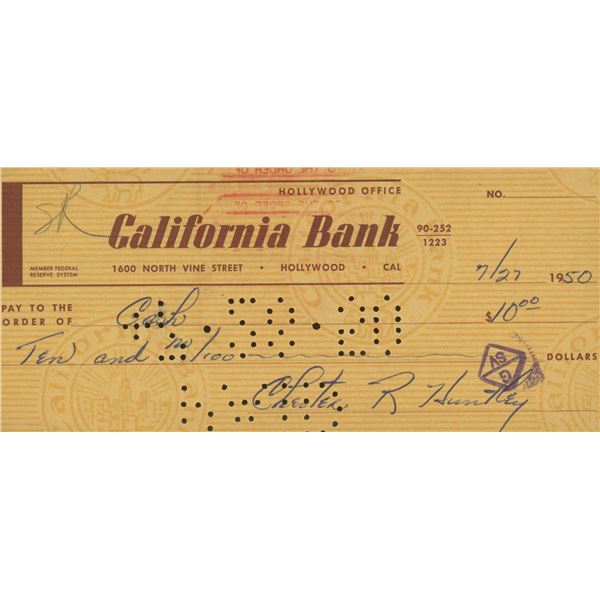 Evening news anchor Chester Huntley signed check