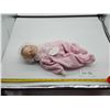 Image 1 : A Porcelain Baby Doll in a Pink Onesie