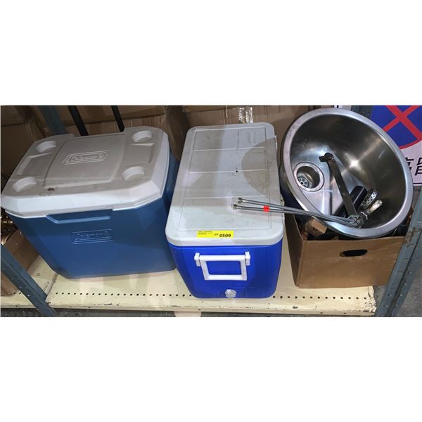 Two Coleman Coolers, sink and assorted frying pans.