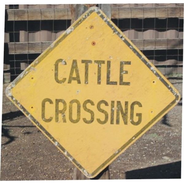 wooden cattle crossing sign