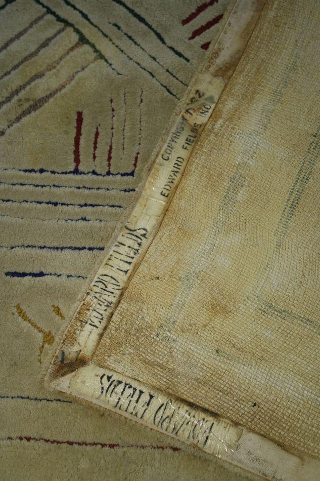 An Edward Fields Rug with Colored Geometric Design on Ivory Field.