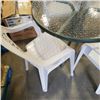 Image 2 : GLASSTOP PATIO TABLE AND 4 STACKING CHAIRS