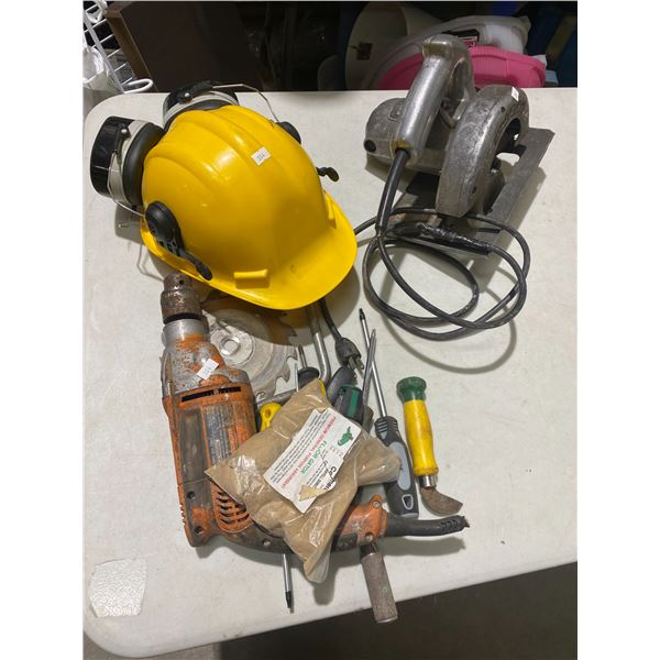 Hard hat, tools, and saw
