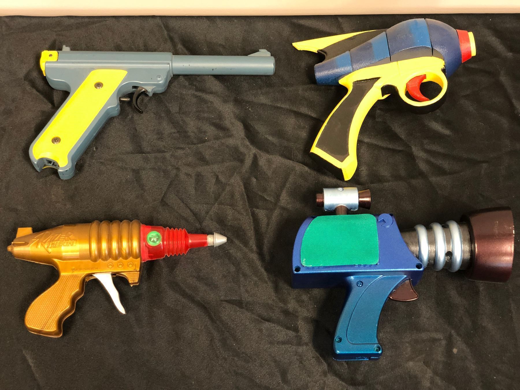 Group of 4 assorted custom designed & painted prop guns
