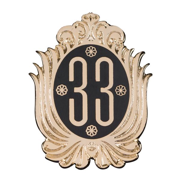 A Club 33 Gold Logo Pin.