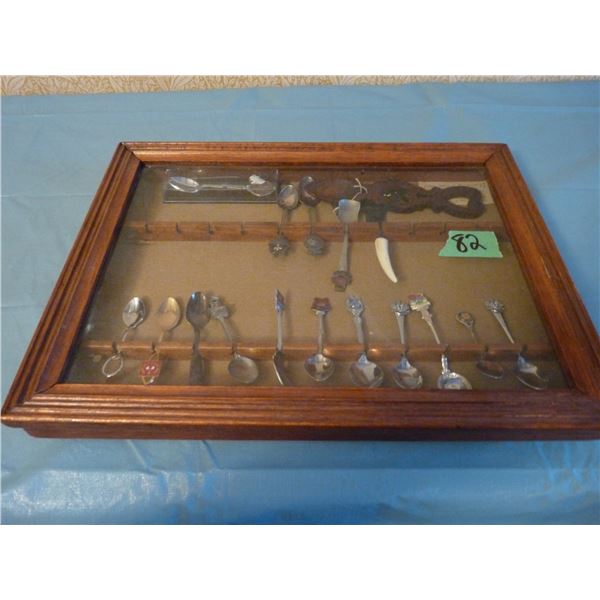 Glass front display case with collector spoons etc