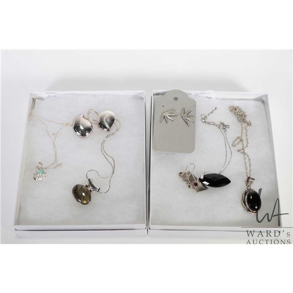 Four sterling silver necklaces and pendants including elephant, two stone pendants and a faceted gem