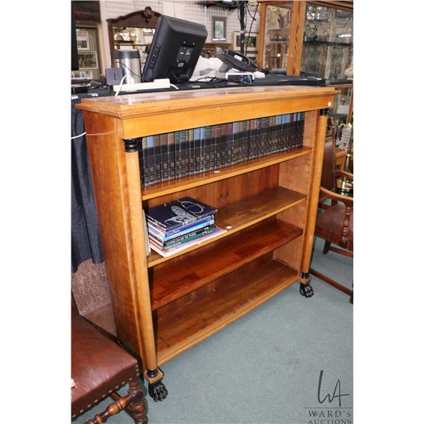 Biedermeier style four tier open bookshelf with large carved paw feet and decorative columns, 52  X 