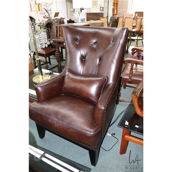 Modern leather style parlour chair with matching throw pillow and nail head decoration