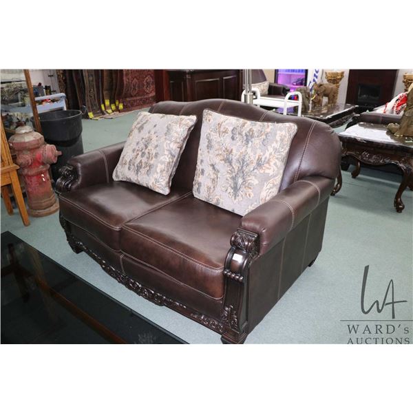 Modern Ashley Furniture bonded leather love seat with decorative show wood, 63" wide