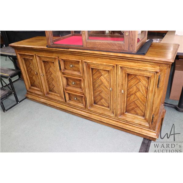 Semi contemporary oak sideboard with two sets of double doors, each exposing adjustable shelf and dr