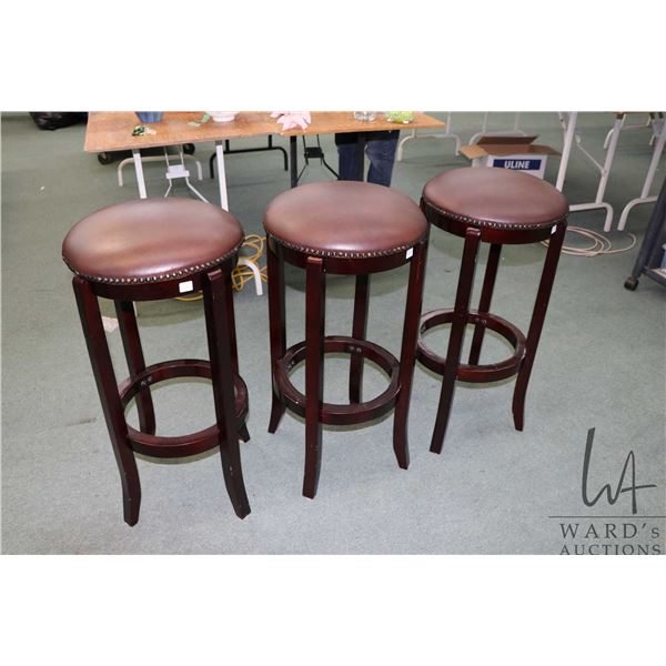 Three matching modern bar stools with leatherette upholstered seats, 30" in height