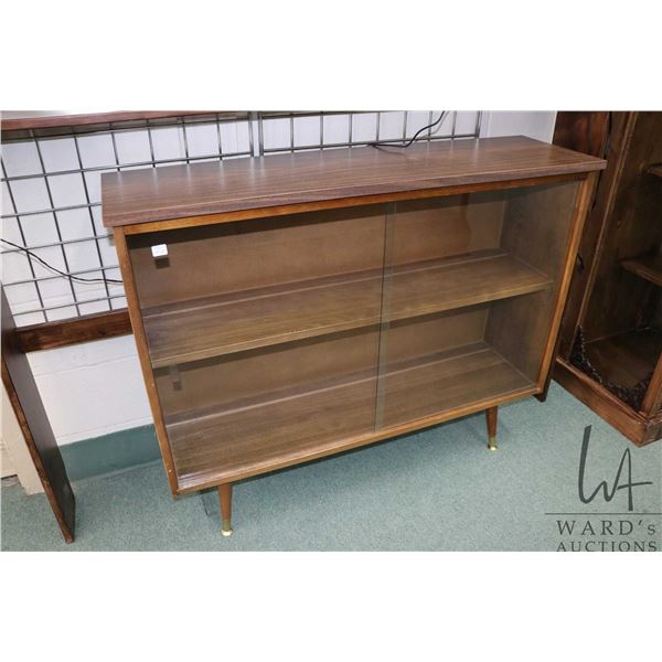 1960's retro curio/book cabinet with sliding glass doors, 42  wide, 12  deep and 34  in height