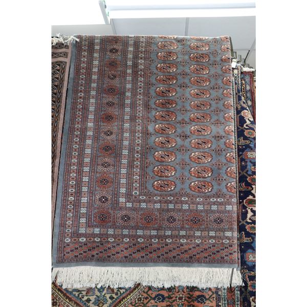 Vintage wool area carpet with grey background with overall geometric design and highlights of mauve,