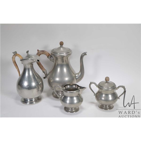 Three pieces of vintage pewter including coffee pot, cream and lidded sugar bowl made by Royal Holla