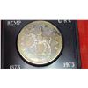 Image 2 : 1973 RCMP Centennial Silver Dollar. Specimen. Lightly Toned. Housed in its original black clamshell 
