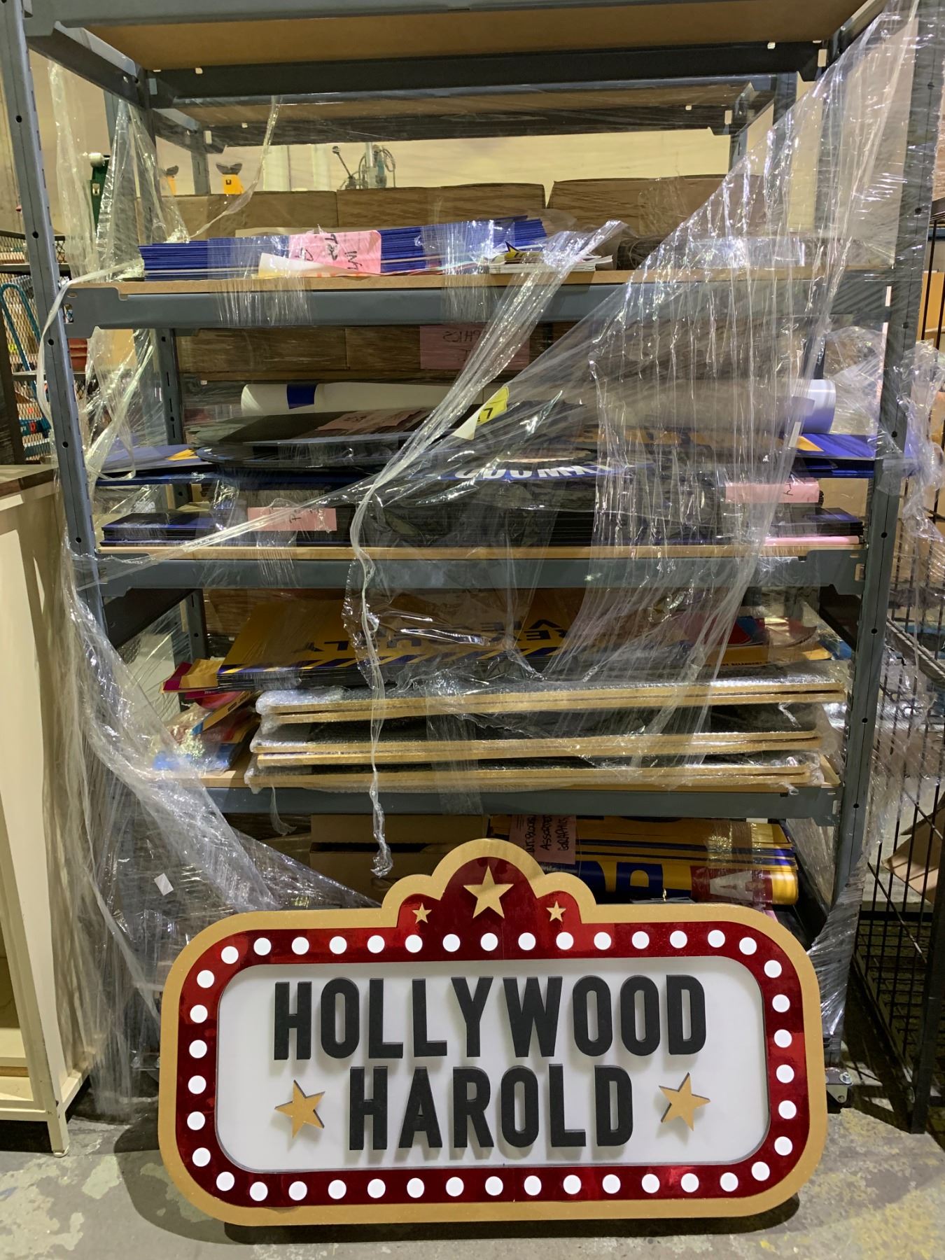 SHELF OF ASSORTED PROP SIGNS AND LIGHT UP SIGN (SHELF NOT INCLUDED)