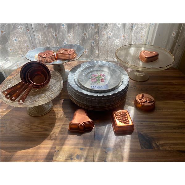 Three Cake Serving Towers with a stack of cake plates and copper cookie cutters