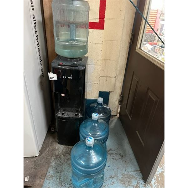 PRIMO WATER COOLER WITH 4 JUGS- 2 ARE FULL. HOT AND COLD WATER.