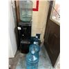 Image 1 : PRIMO WATER COOLER WITH 4 JUGS- 2 ARE FULL. HOT AND COLD WATER.