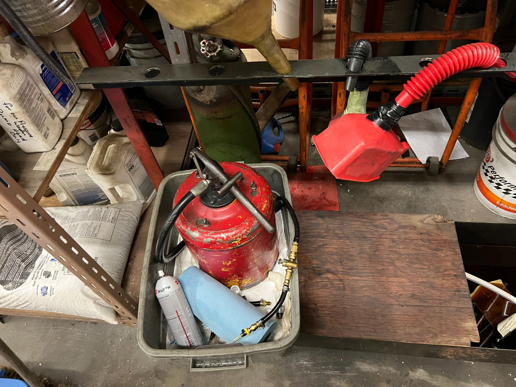 METAL STORAGE RACK WITH OIL CHANGE EQUIPMENT. VACUUM OIL PUMPS, SPOUTS ...