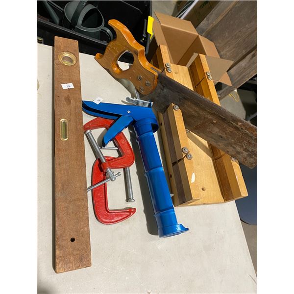 Miter saw, clamps, caulking gun and level