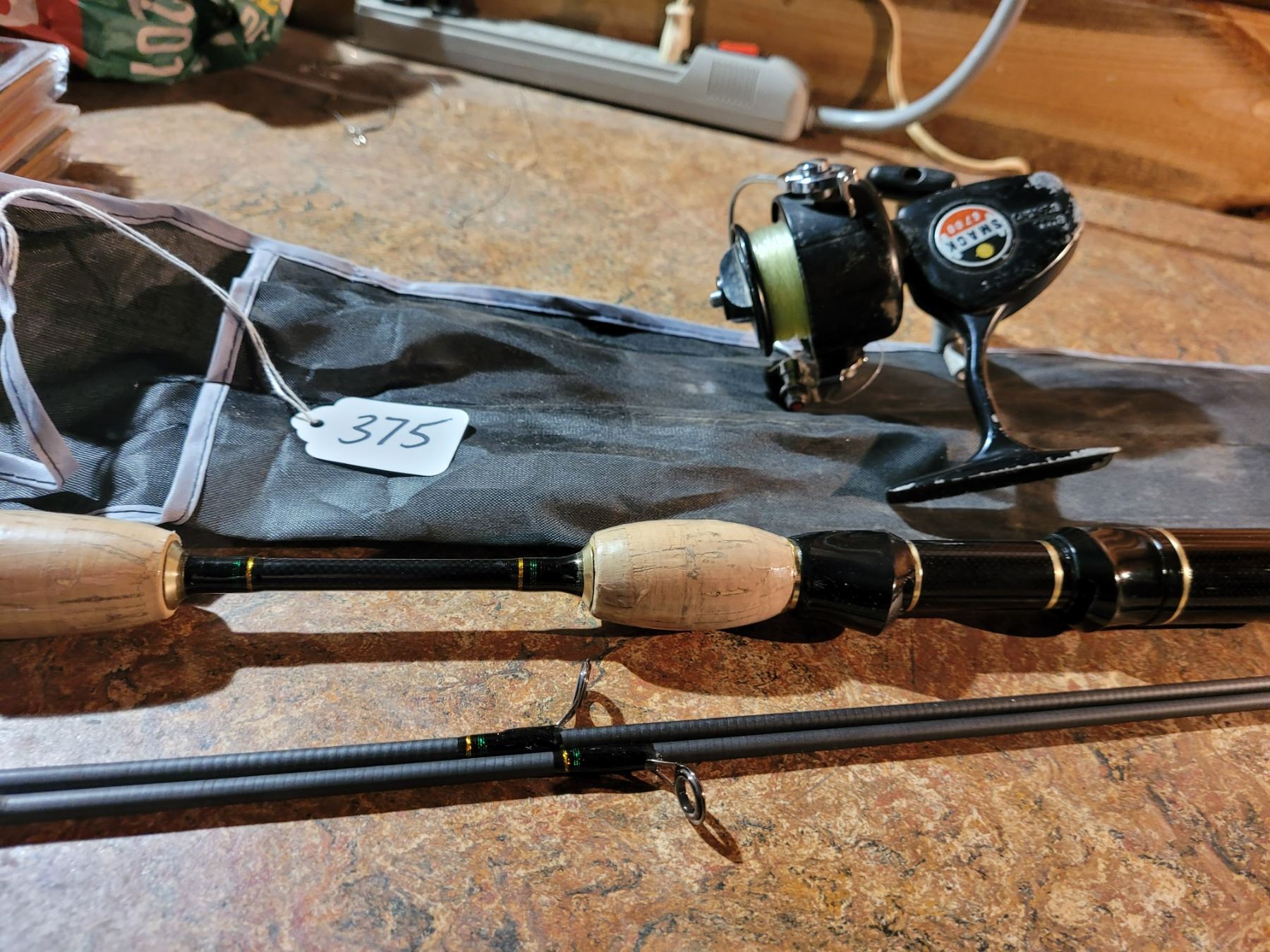 6'6" Rosewood carbon fishing rod with extra second section and case. Also, bonus smack reel