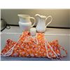 Image 1 : Two porcelain pitchers, vitage apron, candle